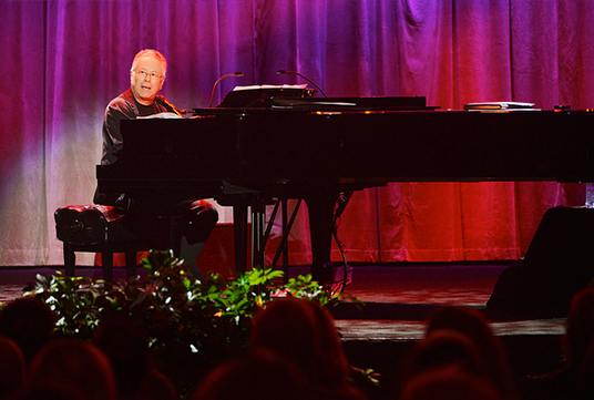 Alan Menken, Tangled Composer, singing at a piano