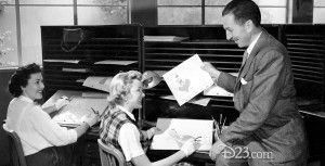 Walt Disney sitting with animators for Alice in Wonderland
