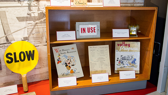 Commissary menus, an employee handbook, equipment, and signage all help tell the story of day-to-day life at the Disney Studio.