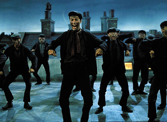 movie still from Mary Poppins showing Disney Legend Dick Van Dyke as Bert in a rooftop dance with several other chimney sweeps