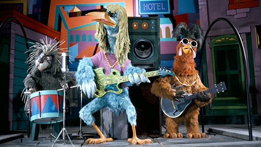 photo of three-member rock band comprised of a porcupine, a tall blue bird, and a hawk wearing sunglasses