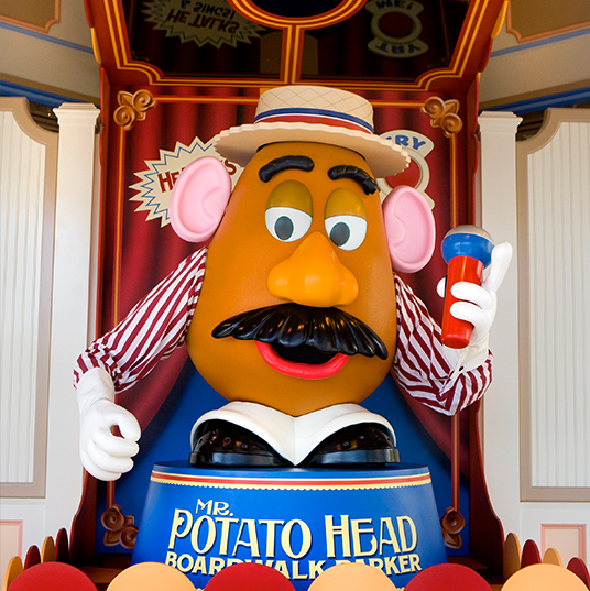 photo of Mr. Potato Head at colorful podium wearing carnival outfit