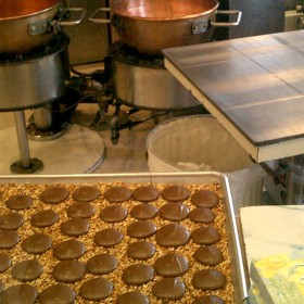 photo of rows of chocolate confections on a cookie sheet in the kitchen of Candy Palace Shop on Main Street at Disneyland