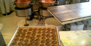 photo of rows of chocolate confections on a cookie sheet in the kitchen of Candy Palace Shop on Main Street at Disneyland