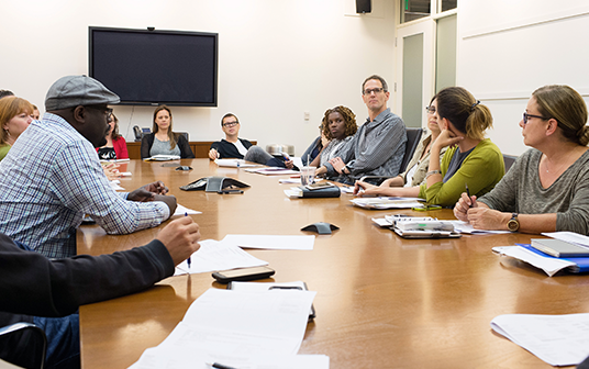 photo of several TVA staffers at a conference table for TVA's weekly Production Status Meeting