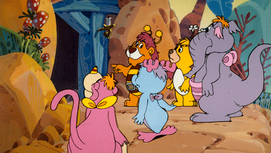 still from animated show featuring five characters at entrance to a cave