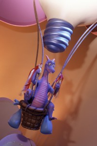 photo of Figment, a purple dragon figurine riding in a hot-air balloon basket