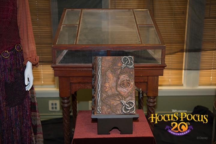 Inside the Walt Disney Archives exhibit, D23 Members and the <em>Hocus Pocus</em> cast and crew come face to face with props and costumes from the film, including Winifred Sanderson's famous spell book.
