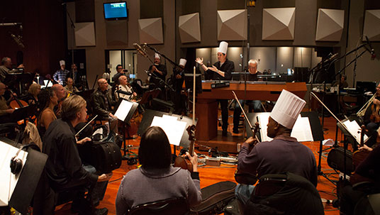Academy Award®-winning composer Michael Giacchino conducting an orchestra