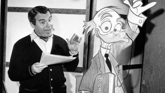 photo of Paul Frees, voice of the Haunted Mansion's Ghost Host, with a drawing of Ludwig Von Drake, for whom he also provided voice 