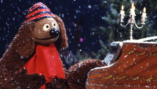 Rowlf the Muppet Dog tickling the keys of an upright piano