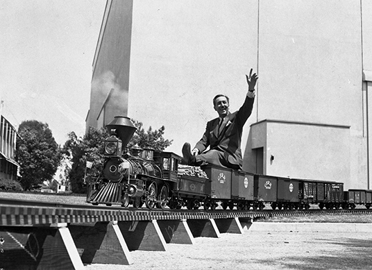 Walt Disney riding on his Carolwood Pacific train