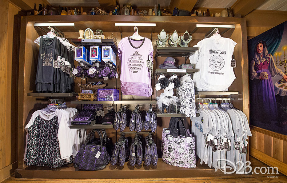 photo of merchandise in store including Madame Leota themed tee shirts, jerseys, purses, shoes, handbags, and bric-a-brac