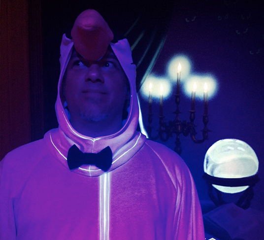 blacklight-illuminated photo of Brian Frey dressed up as a penguin based on those from Mary Poppins