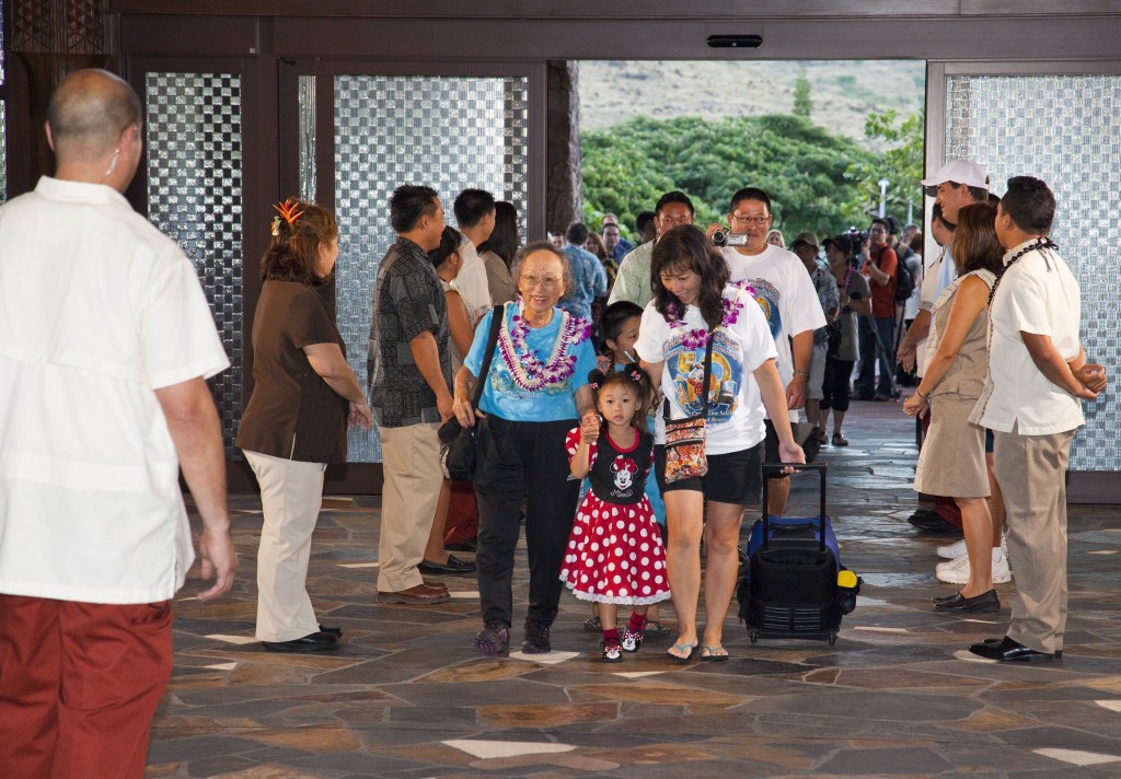 Vacationers including the Chun family---3-year-old Lauren, brother Landon, parents Laura and Brandon, and grandmother Norma Lum---entered the lobby of Aulani, a Disney Resort & Spa, Ko Olina, Hawaii, as its doors opened to guests for the first time, Monday, August 29.  