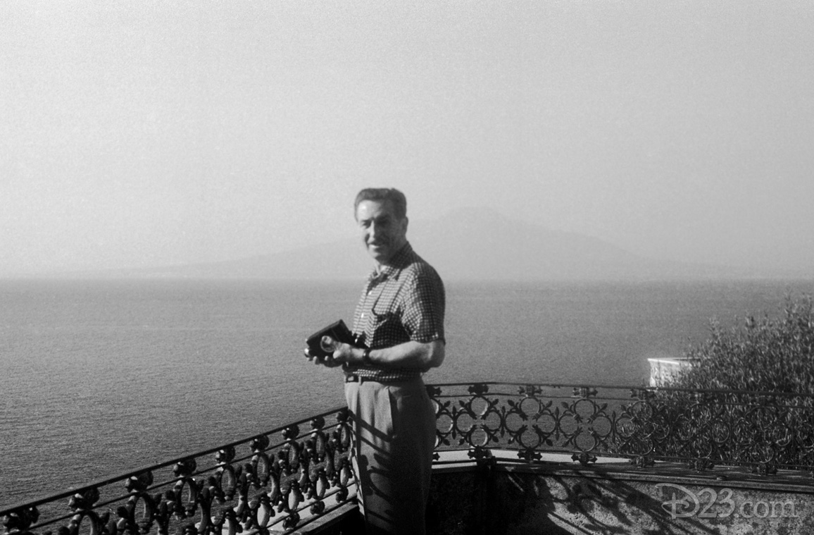 One of the world’s most innovative filmmakers, Walt wouldn’t travel all the way to Italy without a movie camera. Here he is seen with a 16 mm. movie camera in a candid moment along the Italian coast during the 1951 trip.