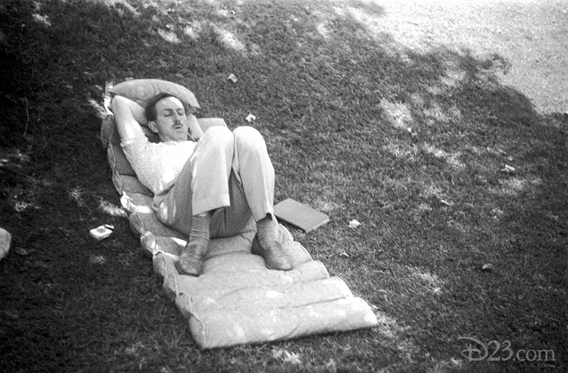 Walt sleeping in the shade on the lawn of his Woking Way home on a state-of-the-art '40-s cushion—a book at his side.