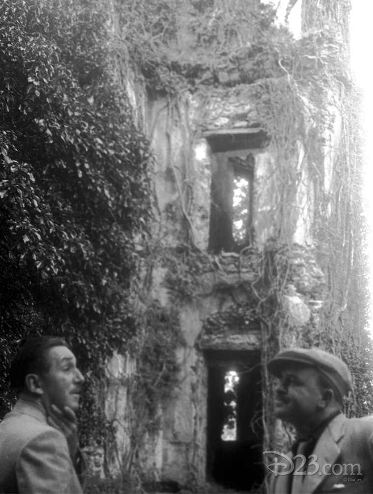 Photo of Walt Disney outside and vine-encrusted cliff-side doorway
