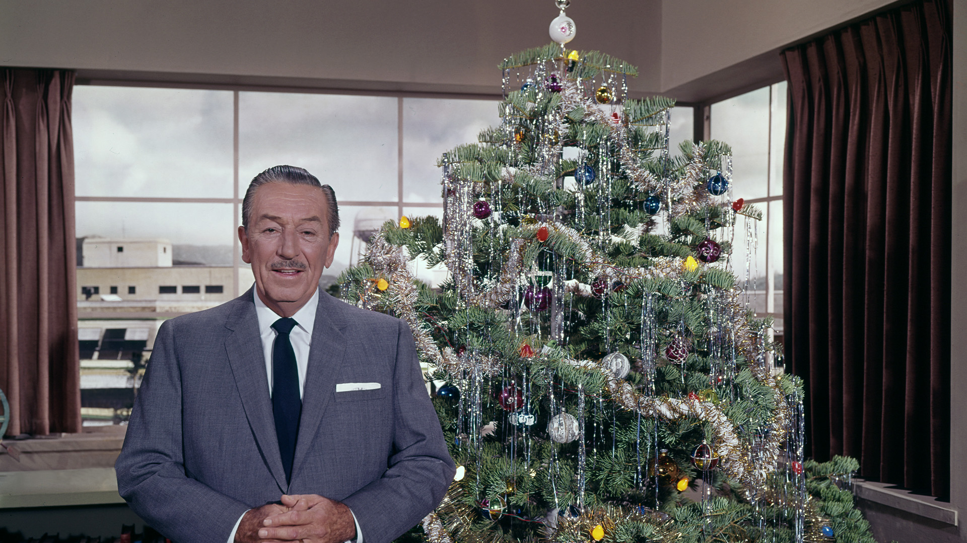 Walt Disney with a Christmas tree