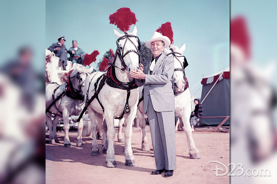 Walt Disney petting a horse.