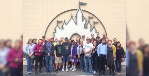 D23 Members standing by the Disney mural at the Walt Disney Studio Lot