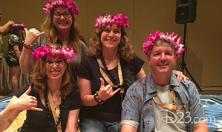 D23 Members showing off their kukui nut bracelets and Hawaiian lei crowns