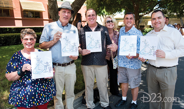 Guest show off their special gift at The Reluctant Dragon 75th Anniversary On the Lot