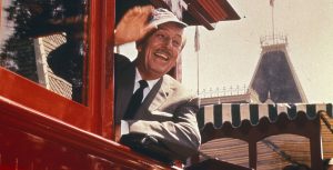 Walt Disney waves from a train