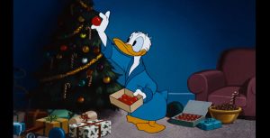 Donald Duck placing an ornament on the Christmas tree