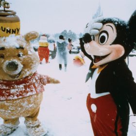 Winnie the Pooh and Mickey Mouse play in the snow