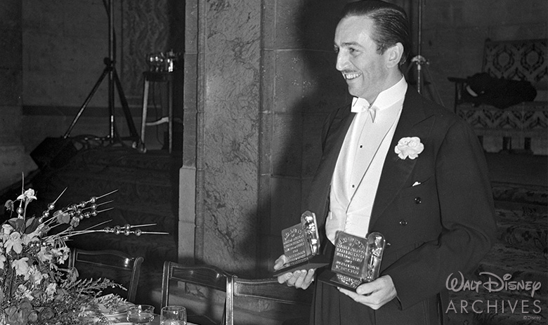 Walt holding two Academy Awards