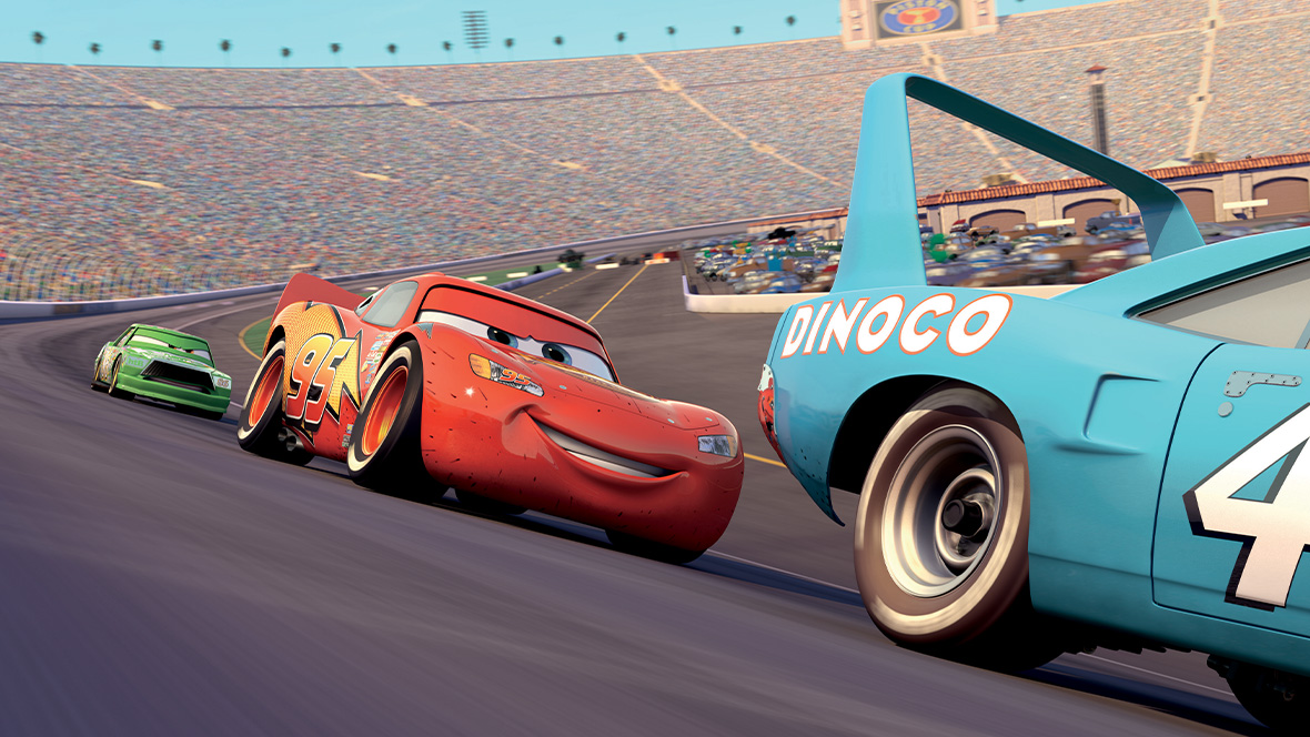 A still of Lightning Mcqueen behind a Dinoco car.