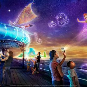 Families stand on the deck of the Disney Wish staring at fantastical realizations of Princess Tiana, Peter Pan, Moana, and more.