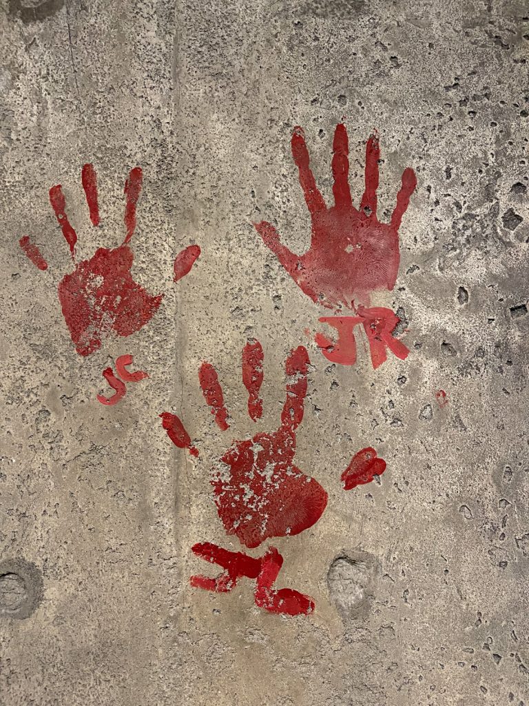 Red hand prints on a wall at Disney's Animal Kingdom.