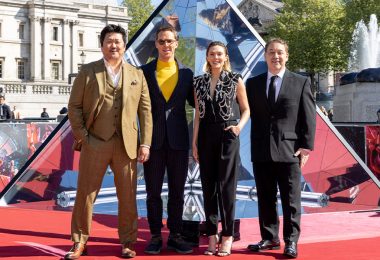 Benedict Cumberbatch, Elizabeth Olsen, and Benedict Wong stand next to each other at a red carpet premiere in Berlin of Doctor Strange in the Multiverse of Madness.