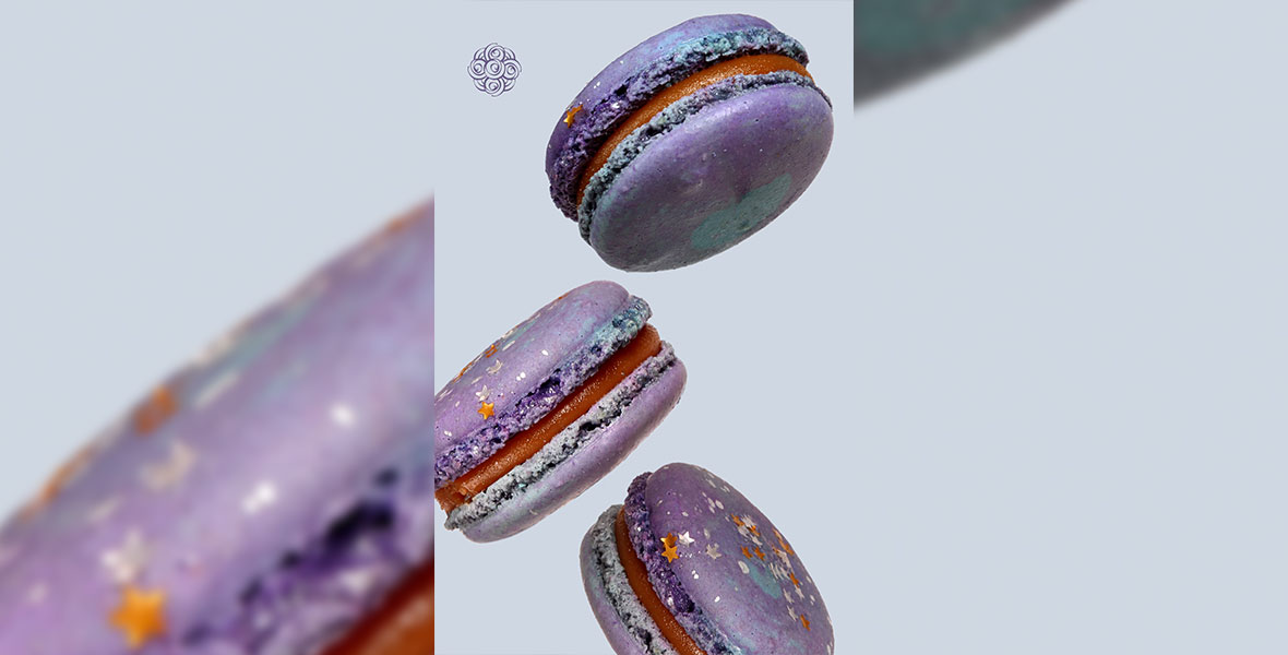 An image of the purple and red Galaxy Caramel macaron from Kayla’s cake, which features colorful sprinkles to denote stars. 