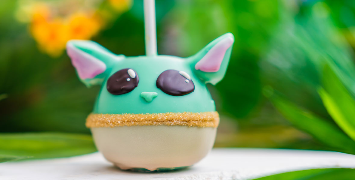 Image of a Grogu, or Baby Yoda, caramel apple from Marceline’s Confectionary, featuring marshmallow ears and gold sanding sugar for a belt.