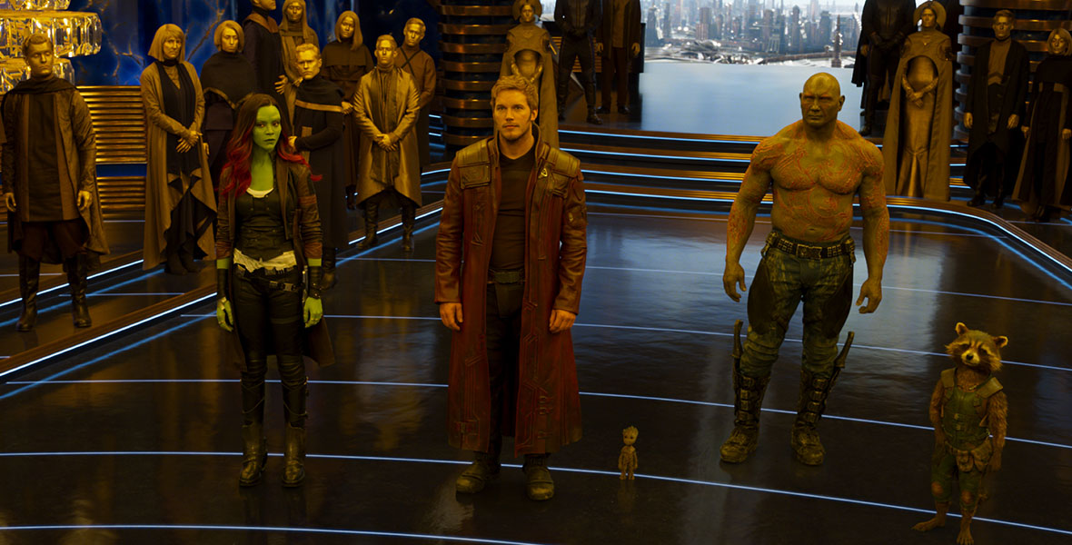 Gamora (Zoe Saldana), Peter Quill aka Star-Lord (Chris Pratt), Drax (Dave Bautista), Groot (voiced by Vin Diesel), and Rocket (voiced by Bradley Cooper) stand before the Sovereign people in Marvel Studios’ Guardians of the Galaxy Vol. 2.