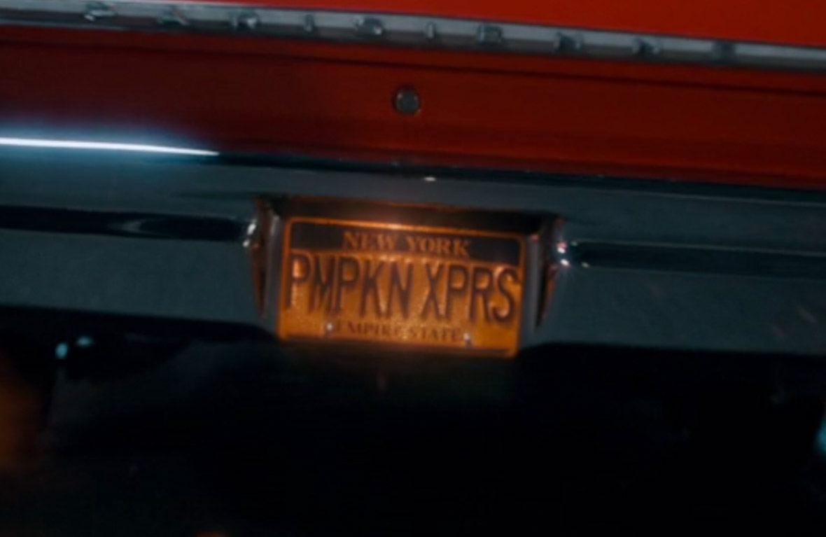 A license plate reading “PMPKN XPRS” on an orange convertible.