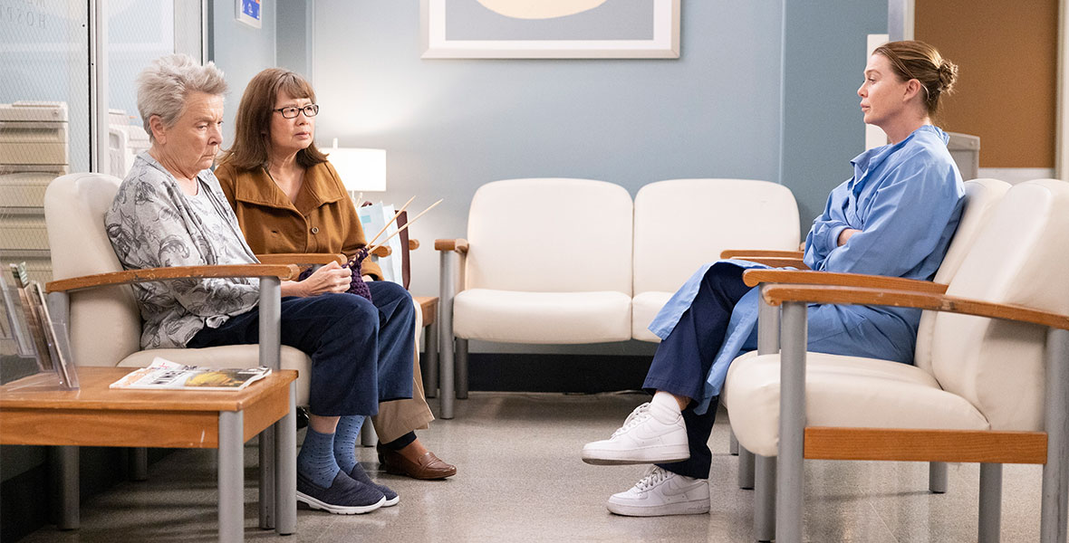 Actress Ellen Pompeo sits across from a patient’s family in a hospital waiting room on Grey’s Anatomy.