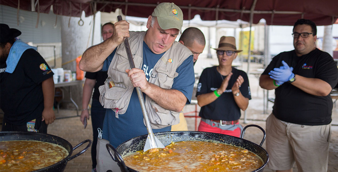 Chef José Andrés stirs a pot of food in San Juan, Puerto Rico, in the documentary film We Feed People.