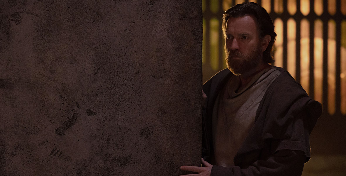 Actor Ewan McGregor, who portrays Obi-Wan Kenobi, peeks around a corner during a scene in the Disney+ series Obi-Wan Kenobi.