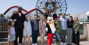 Martellus Bennett, Jett Bennett, Libby Rue, Harvey Guillen, Ayo Davis, Yvette Nicole Brown, Donald Faison, Ruthie Righi pose with Mickey Mouse in Pixar Pier during Disney Junior Fun Fest