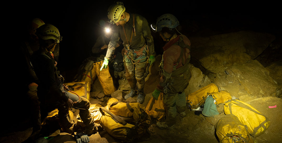 Team members inside Cheve Cave organize packs, which contain all their food and gear while staying inside Cheve Cave.
