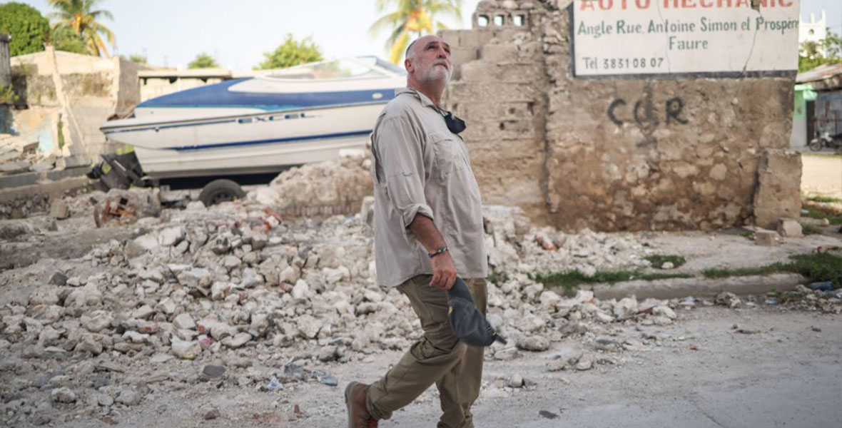 José Andrés walking through rubble from collapsed building remains in Haiti after a 2021 earthquake, in the documentary film We Feed People.