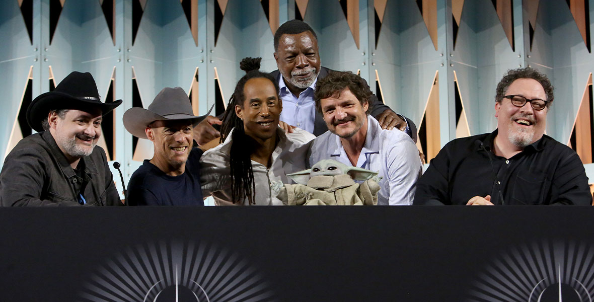 Dave Filoni, Brendan Wayne, Lateef Crowder, Carl Weathers, Pedro Pascal, Grogu, and Jon Favreau at the panel Mando+ :  A Conversation with Jon Favreau & Dave Filoni at Star Wars Celebration