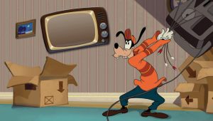 Goofy, wearing an orange and red shirt and dark green pants, is swinging several TV components by their cables in a still from the animated short How to Hook Up Your Home Theater.