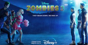 In a promo image for ZOMBIES 3, Milo Manheim as zombie Zed (with green hair) and Meg Donnelly as cheerleader Addison (in her cheer uniform) stand on one side, and three aliens all dressed in futuristic outfits, including Matt Cornett as A-lan, standing on the other side under the bright lights of a spaceship. There are tree-covered hills in the background.
