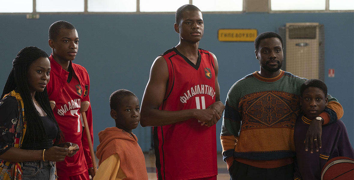 The Antetokounmpo family gathers on a basketball court following Giannis and Thanasis’ game in Disney’s Rise.