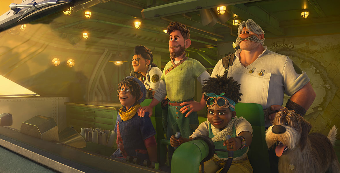 A still from Walt Disney Animation Studios’ Strange World. The Clade family is inside a vehicle of some kind; there are five humans and one dog, and all the humans are wearing muted colors, mostly in greens, browns, and blues. One is wearing goggles on top of their head. All are looking out the windshield of the vehicle, with smiles on their faces.